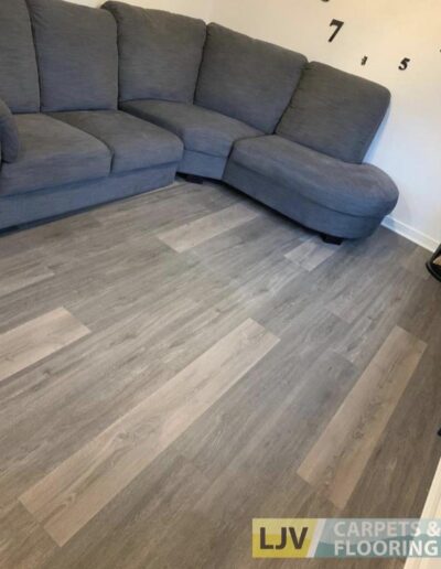Grey couch and LJV Carpets & Flooring